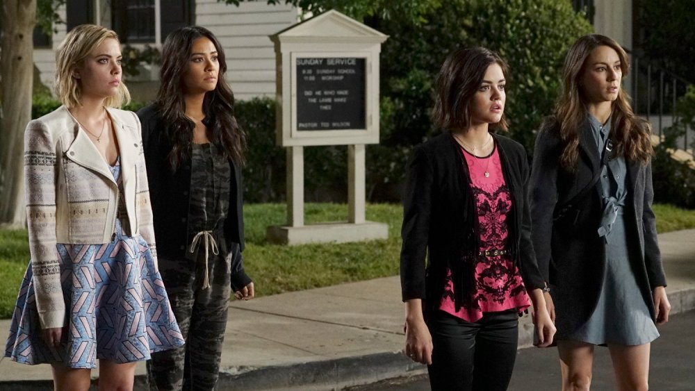 Ashley Benson as Hanna, Shay Mitchell as Emily, Lucy Hale as Aria and Troian Bellisario as Spencer look scared while standing in the middle of a street in Pretty Little Liars