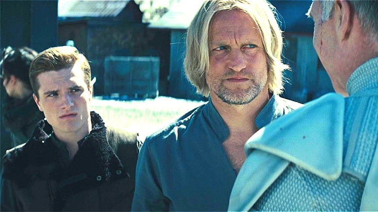 Peeta and Haymitch facing a Peacemaker