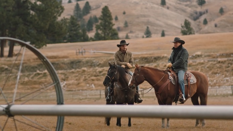 Kayce and John Dutton sitting on horses 