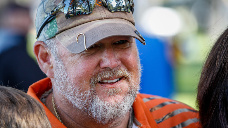 Larry the Cable Guy wearing baseball hat with fish hook