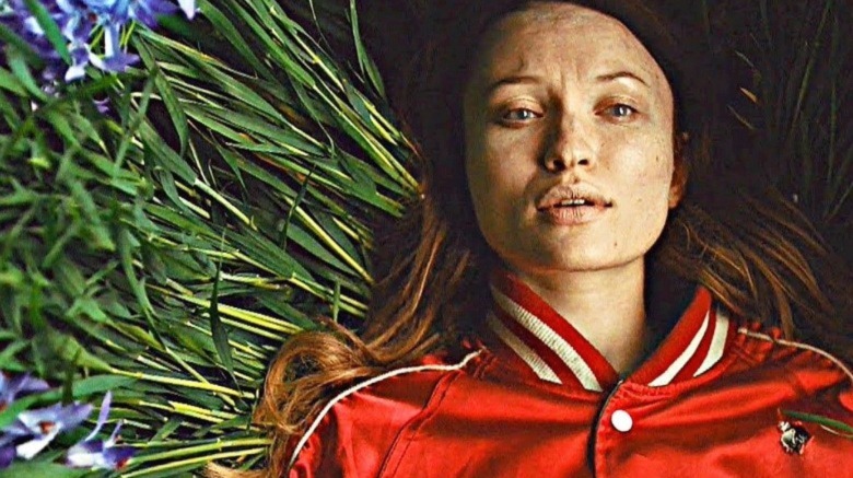 Laura Moon (Emily Browning) lying in a field of flowers in American Gods