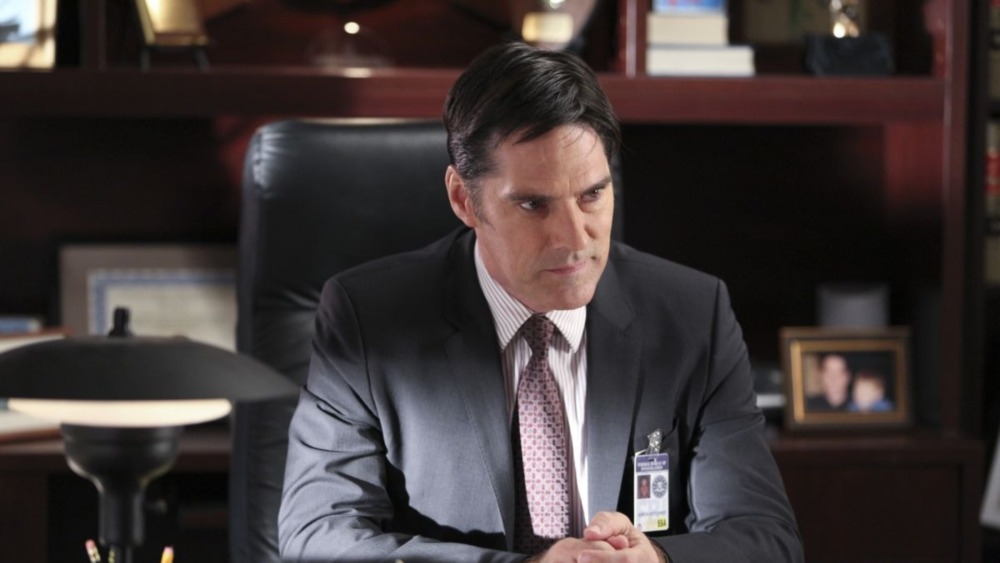 Hotch sits at a desk