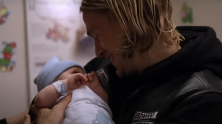 Jax holds baby Abel