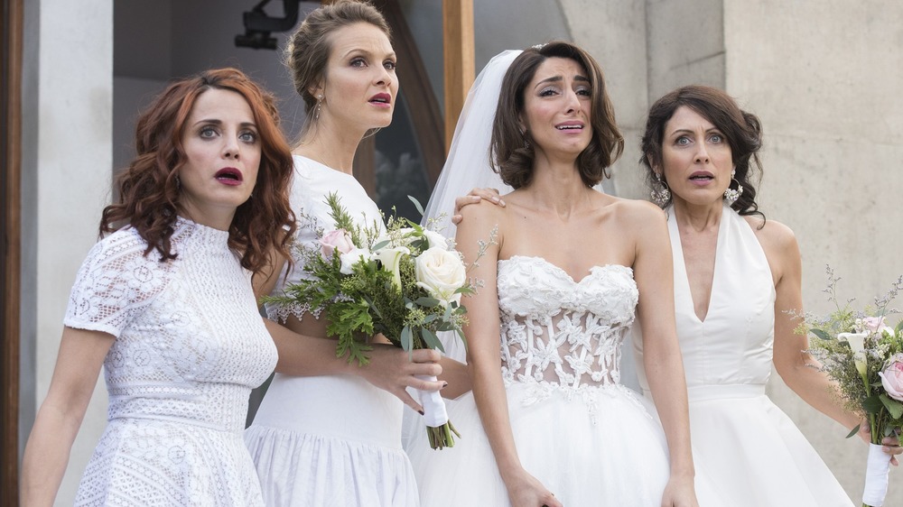 Abby McCarthy shocked with friends in wedding dresses