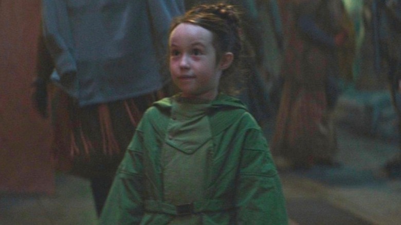 Young Leia wearing a green cloak