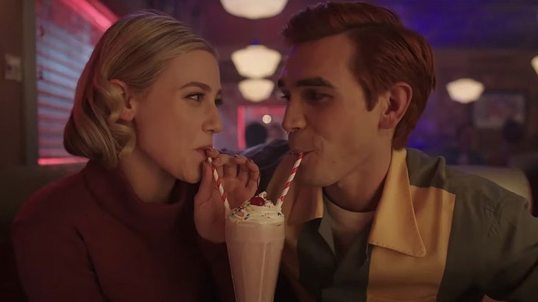 Betty and Archie sip milkshake