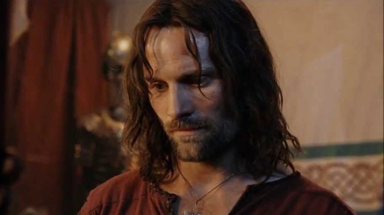 Aragorn looks at Andúril reforged