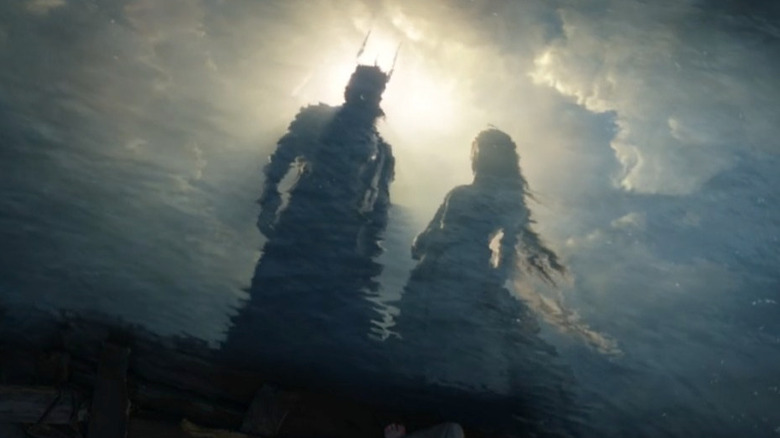 Sauron and Galadriel reflected in the water