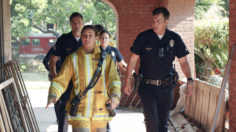 John Nolan walking with a firefighter and other LAPD members