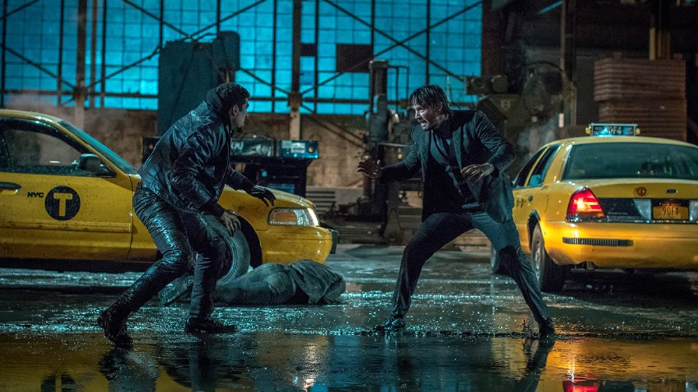 John Wick and an opponent square off during the intense garage fight in Chapter 2