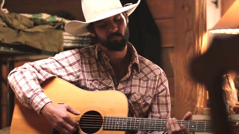 Bingham playing guitar on Yellowstone