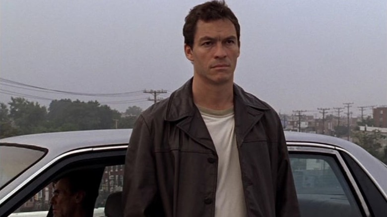 Jimmy McNulty stands in front of a car in "The Wire" (2008)