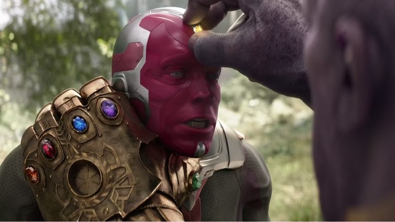 Vision clutched by Thanos