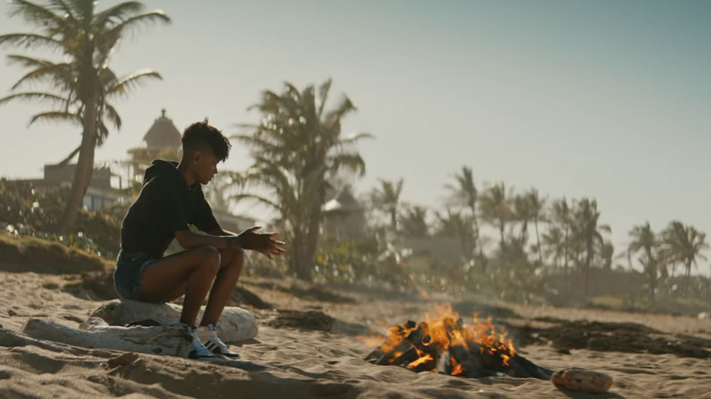 Shuri burns her funeral garments on the beach