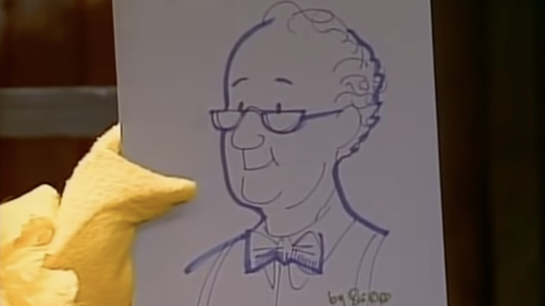 Big Bird holds drawing of Mr. Hooper