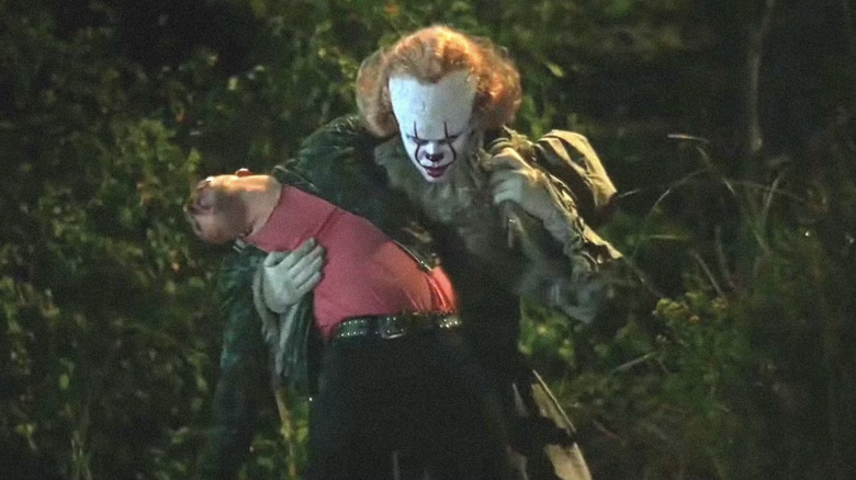 Pennywise holding Adrian 