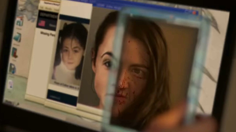 Leena looks at her own bloodied face in a mirror beside photos of a girl