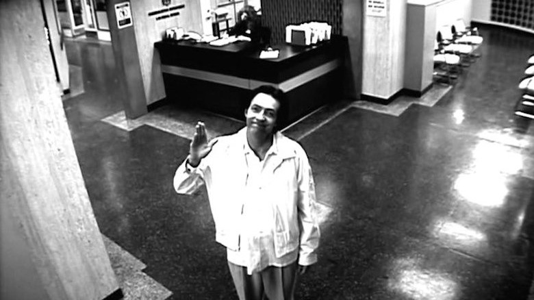 Paul Millander waving at a security camera