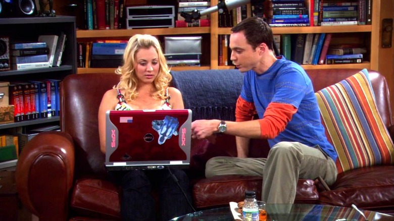 Sheldon and Penny look at a laptop