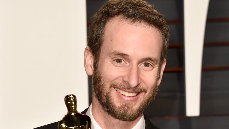 Chris Williams smiling with an Academy Award