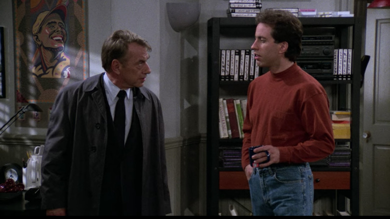 Jerry is confronted in his apartment by Mr. Bookman