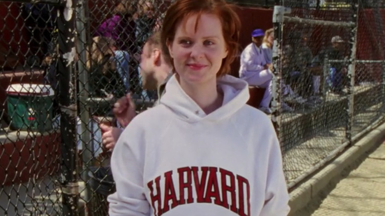 Miranda in Harvard sweatshirt, smiling