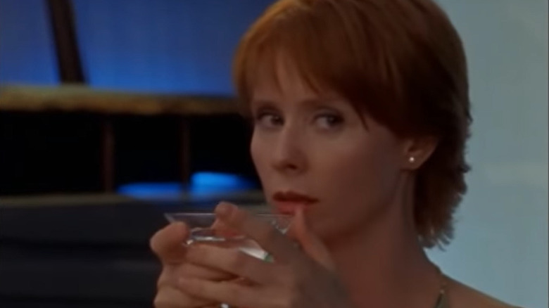 Cynthia Nixon holding a drink in her hands