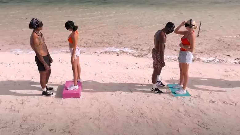 Two blindfolded couples on beach