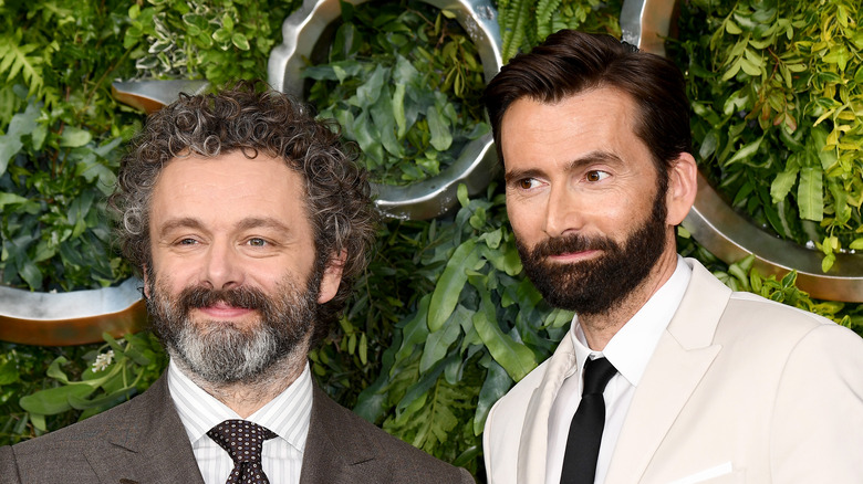 Michael Sheen and David Tennant smile on red carpet