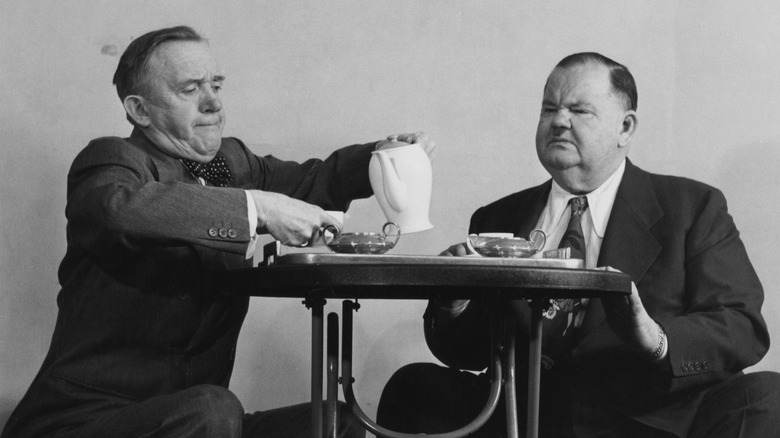 Stan Laurel and Oliver Hardy pouring tea