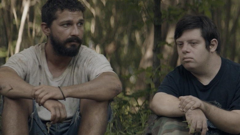 Shia Labeouf and Zack Gottsagen sitting together