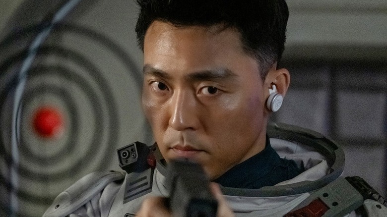 Captain Song holds a gun