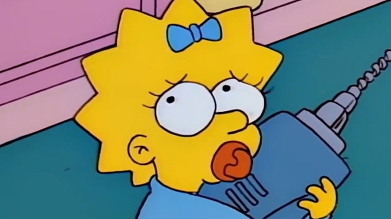 Maggie Simpson clutching a power drill