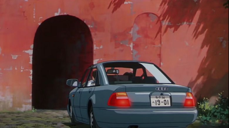 Car parked in front of tunnel entrance 