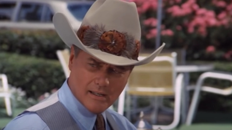 Larry Hagman in cowboy hat by pool