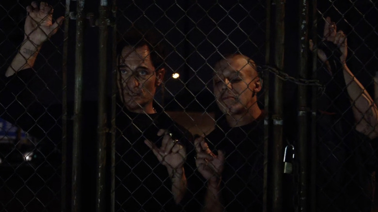 Juice and Tig leaning on a fence