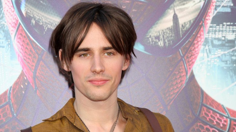 Reeve Carney with Spider-Man poster