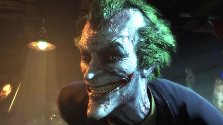 The Joker grinning in close-up as he appears in the Batman: Arkham games