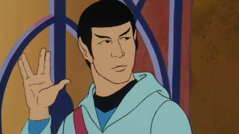 Spock looks right and gives the hand gesture