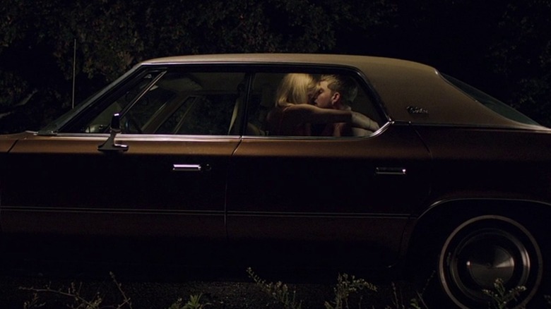 Couple kissing in back of car