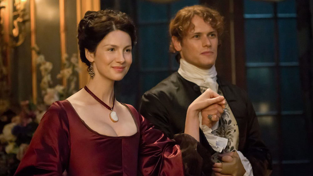 Caitríona Balfe and Sam Heughan smiling in Outlander