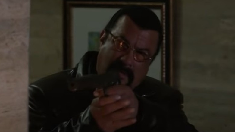 Steven Seagal pointing a gun