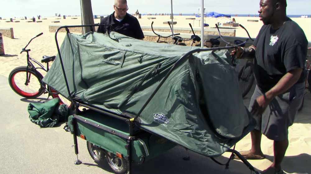 Ivy Calvin helps Kenneth assemble the mini-camper