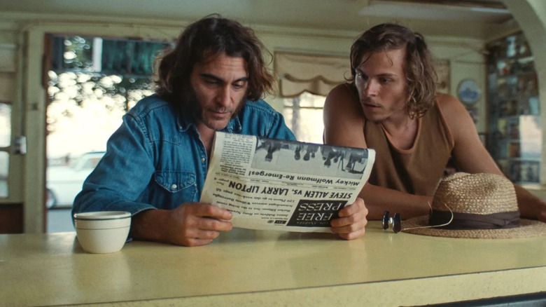 Doc and Denis reading newspaper