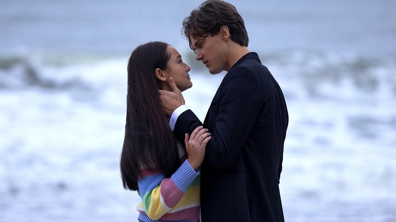 Belly and Conrad embracing in front of the ocean in "The Summer I Turned Pretty."