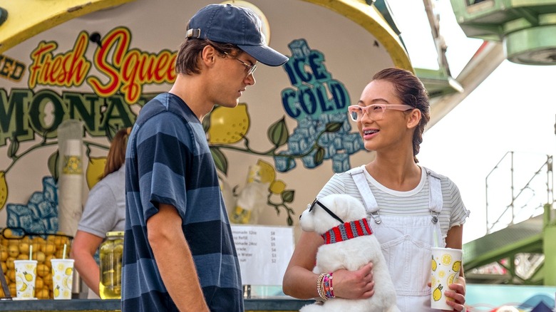 Conrad and Belly standing in front of a lemonade stand in "The Summer I Turned Pretty."