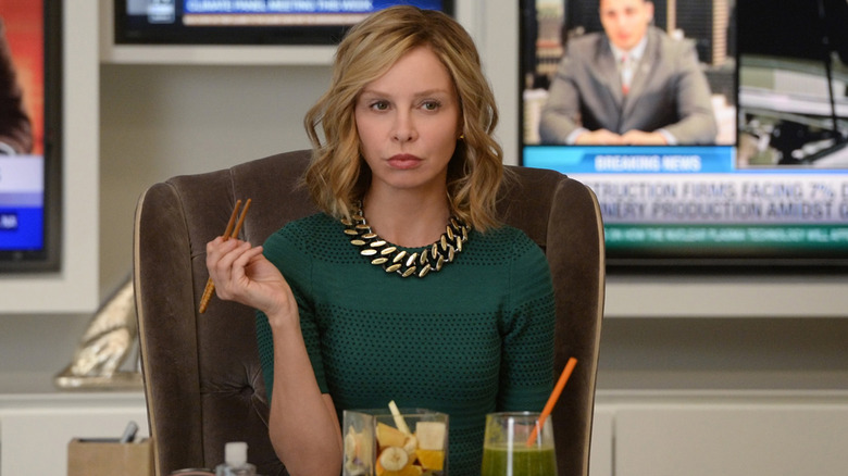 Cat Grant at desk holding chopsticks