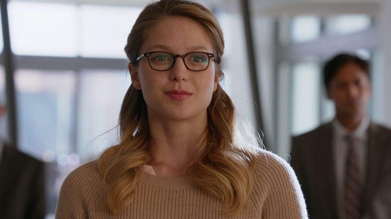 Kara in beige sweater and glasses