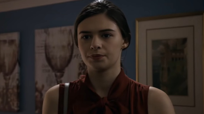 Nia Nal wearing red blouse