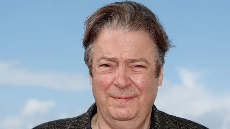 Roger Allam squinting outside